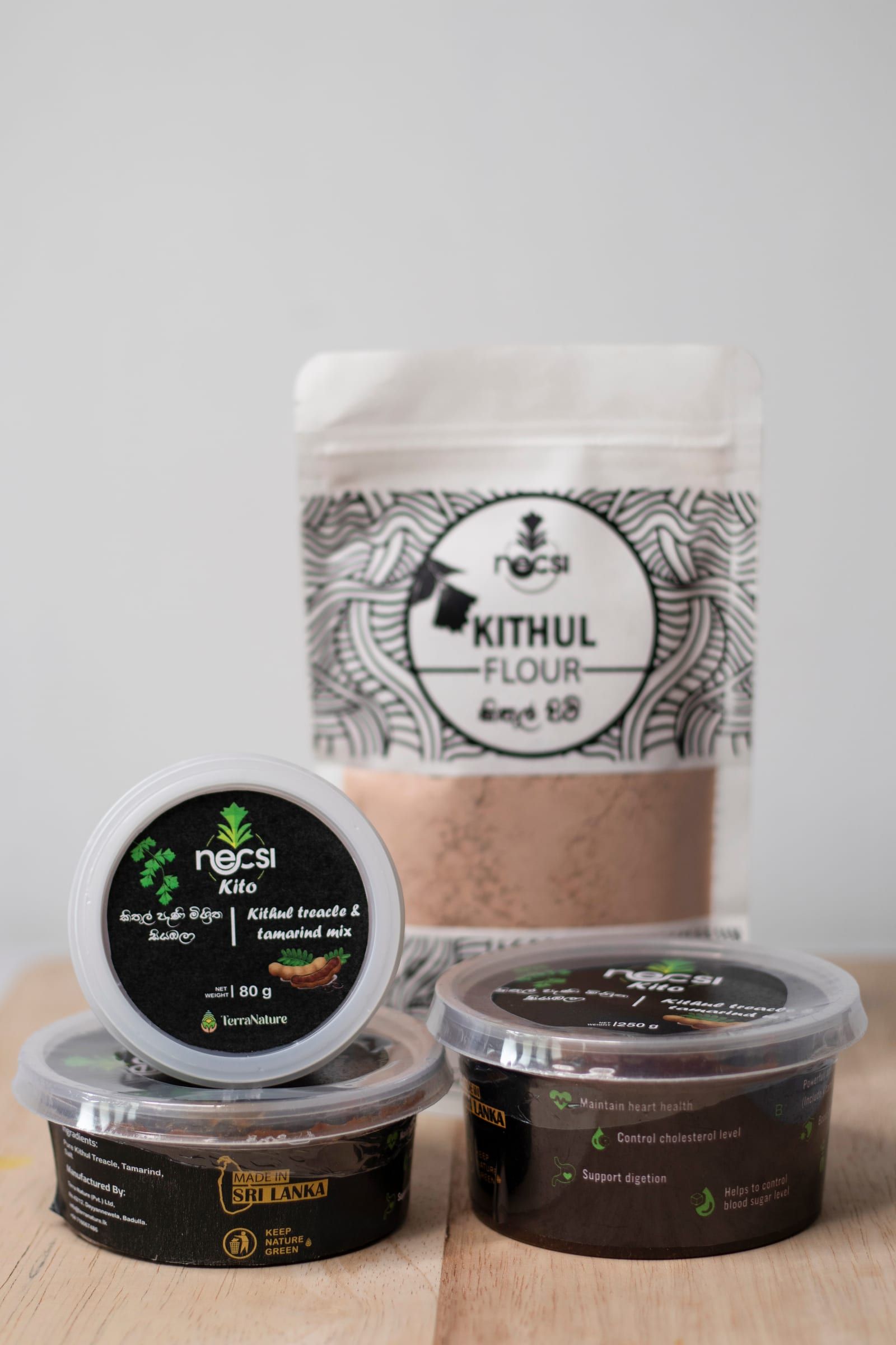 Necsi Kito tubs in three sizes in front of a pouch of Necsi Kithul Flour